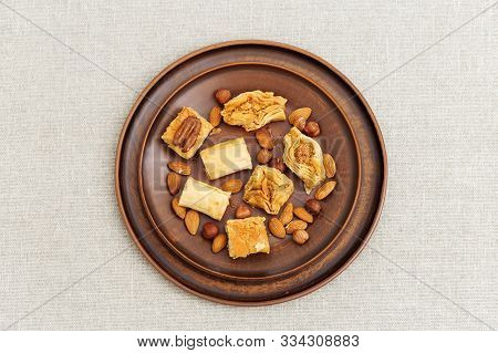 Turkish Sweet With Chopped Nuts And Honey. Delicious Middle Eastern Honey Dessert On Clay Plate. Top