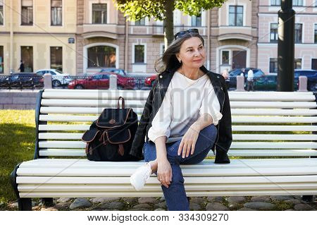 Cheerful Beautiful Mature European Female In Her Fifty Enjoying The Nice Summer Weather Outdoors, Si