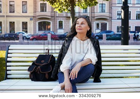 Cheerful Beautiful Mature European Female In Her Fifty Enjoying The Nice Summer Weather Outdoors, Si