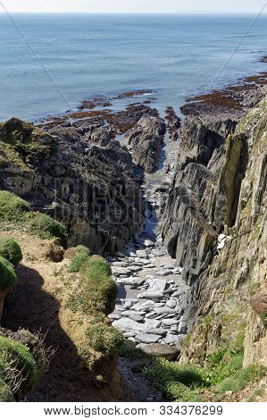 Cliffs With Vertical Rock Strata At Windy Cove, Morte Point, North Devon
