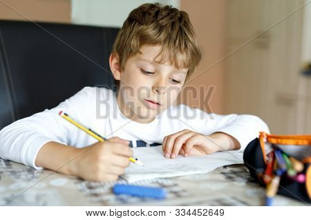 Tired Little Kid Boy At Home Making Homework At The Morning Before The School Starts. Little Child D
