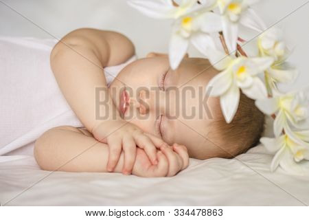 Sleeping baby. Cute kid sleeping on bed in bedroom. ?hild sleeps and sees a dream.