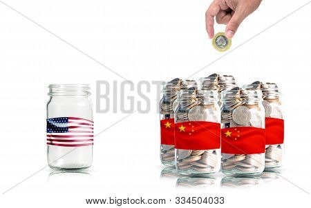 Hand Putting Coin For China Jar Wit Coin And Empty Usa Jar.it Is Symbol Of Economic Tariffs Trade Wa