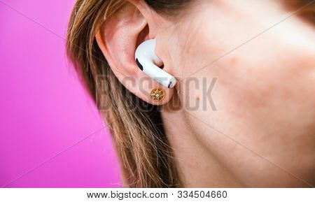 Paris, France - Oct 30, 2019: Meditative Woman Immersed In Music Using New Apple Computers Airpods P