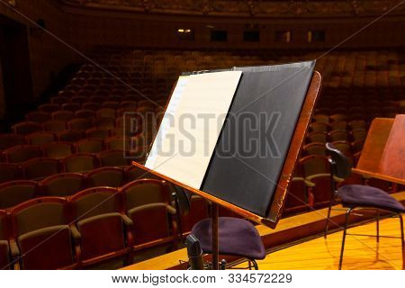 Music Book And Sheets With Musical Notation On The Stand Ready To The Concert. Equipment Of The Orch