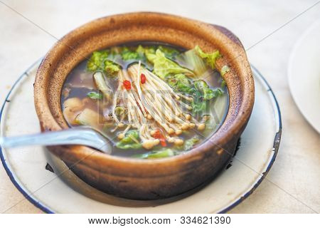 Bak Kut Teh Or Hokkiens Topping With Golden Needle Mushroom Or Enokitake In Earthenware Pot In Broth