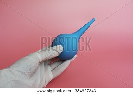 Blue Syringe With A Soft Tip In The Female Hand Of A Doctor.