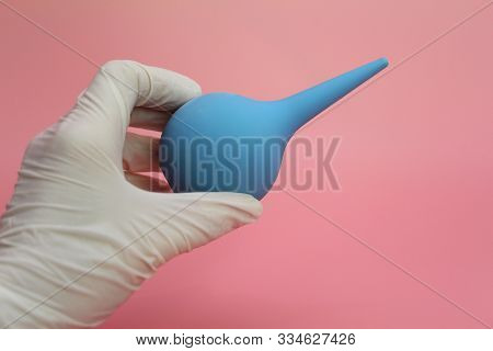Blue Syringe With A Soft Tip In The Female Hand Of A Doctor.