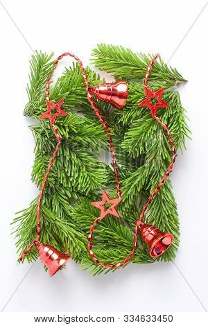 Creative Christmas Composition. Red New Eyar Garland On The Branches Of Spruce. Minimal Layout, Flat