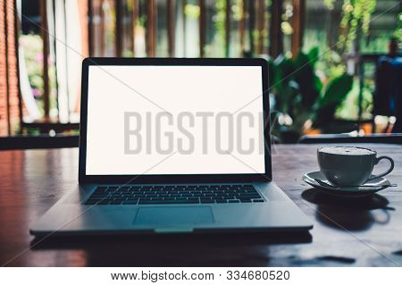 A Cup Of Cappuccino Coffee With Laptop White Screen On Table. Royalty High Quality Free Stock Photo 