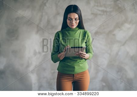 Photo Of Seriouc Concentrated Focused Woman Looking Through Found Information On Her Tablet In Spect