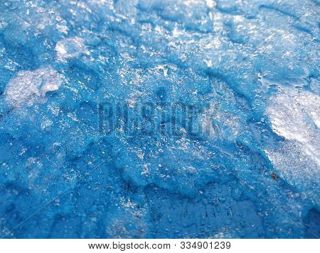Ice Texture With Icy Snow On The Blue Background. Abstruction Atmosphere. White