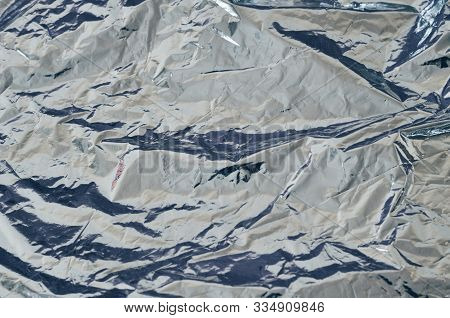Silver Shiny Metallic Sheet Foil With Crumpled Surface Texture Background