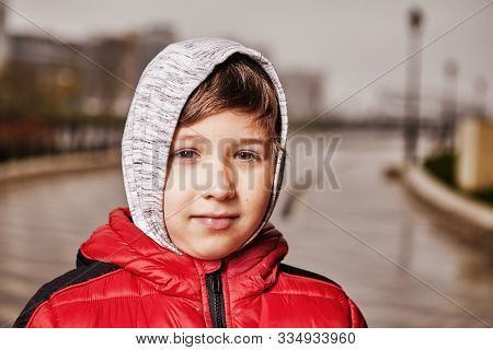 Close-up Portrait Of A Seven-year-old Child In Warm Clothes Outdoors. A Boy In A Warm Jacket, Under 