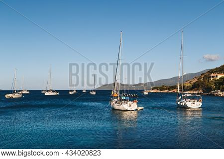 White Yachts Anchored In Blue Bay Of Agia Efimia Port, Cephalonia Island, Greece