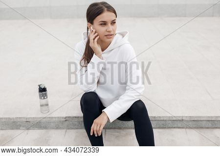 A Young Athlete Does Stretching And Warm-up Before Doing Yoga. Fitness Girl Workout In The Gym, Whit