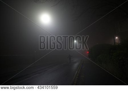 Happy Lone Man Enjoys Freedom As He Runs Up A Deserted Street With Arms Outstretched. Extremely Fogg