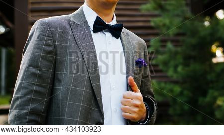 Man In Suit, Plaid Jacket, White Shirt And With Bow Tie Outdoors, Cropped Image. Selective Focus On 