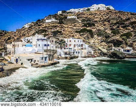 Kastro and its small Harbor, waves during a sunny day, Sifnos, Greece