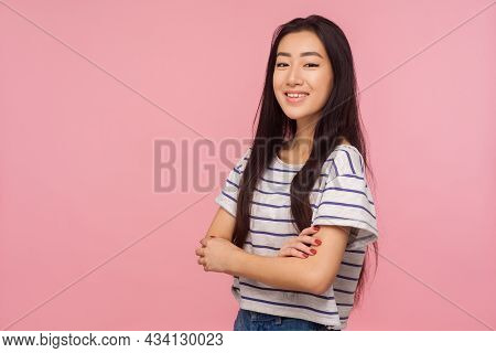 Portrait Of Charming Positive Girl With Long Brunette Hair In Striped T-shirt Holding Arms Crossed A