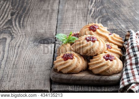 Qurabiya  Cookie Shortbread With Jam On Rustic Wooden Table