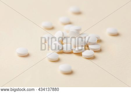 Biotin Tablets. Bright Paper Background. Close Up.