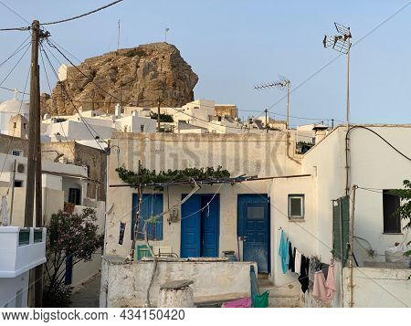 Pedestrian street of Greek Chora village built around a large rock on Amorgos island, Aegean Sea, Cyclades, Greece