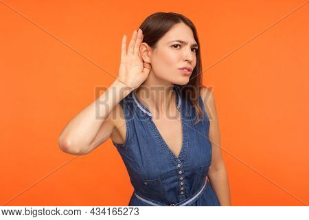 Attentive Nosy Brunette Woman In Denim Dress Overhearing, Listening Intently To Secret Information, 