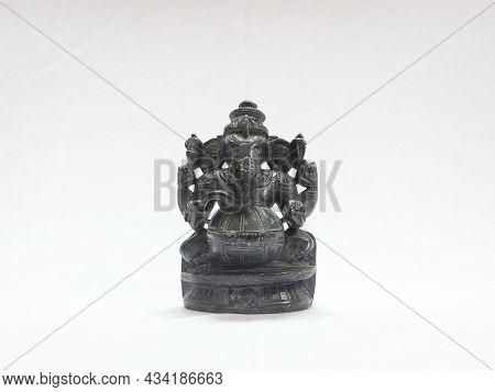 Hindu God Lord Ganesh Traditional Antique Black Rock Sculpture In White Background
