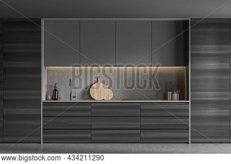 Modern Dark Wood Kitchen Interior With Stylish Cabinets And A Niche With A Stove And A Sink. A Conce