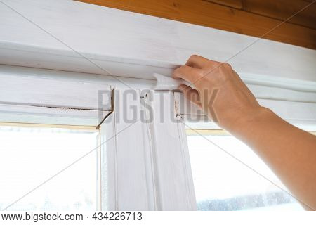 Woman Hand Insulating Old Windows To Prevent Warmth Heat Leak And Drafts, Preparing House For Winter