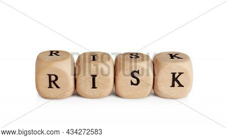 Word Risk Made Of Small Wooden Cubes On White Background