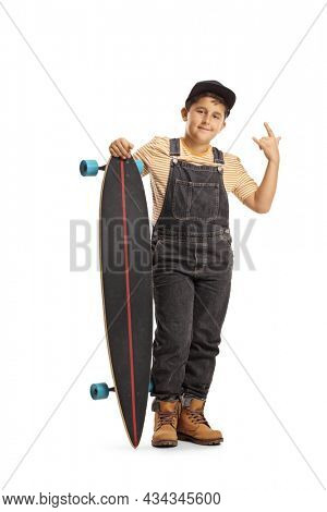 Full length portrait shot of a cool boy posing with a longboard and gesturing a rock and roll sign isolated on white background