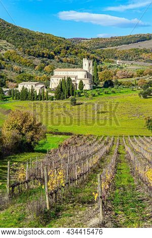 Charming abbey among vineyards and fields. Sunny day at the beginning of winter. Abbey of Sant Antimo. The magical beauty of the province of Tuscany. Magnificent Italy.