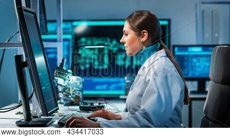 Workplace Of Young Woman In Modern Microelectronics Manufacturing Lab. Engineer Works In A Modern Sc