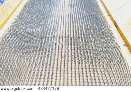 The Seat Is Made Of Sharp Nails. A Lot Of Nails Are Driven Into The Chair. The Concept Of Overcoming