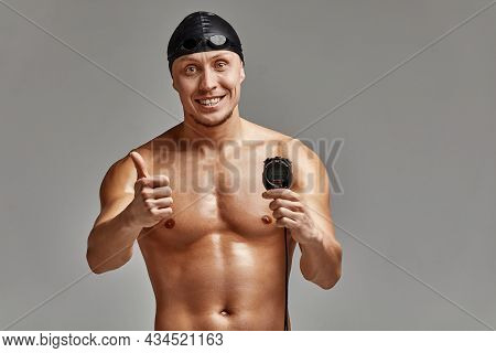 Excited Swimer With Stopwatch Standing On Gray Background. New Record. Motivation, Advertising Banne