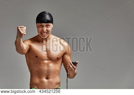 Excited Swimer With Stopwatch Standing On Gray Background. New Record. Motivation, Advertising Banne