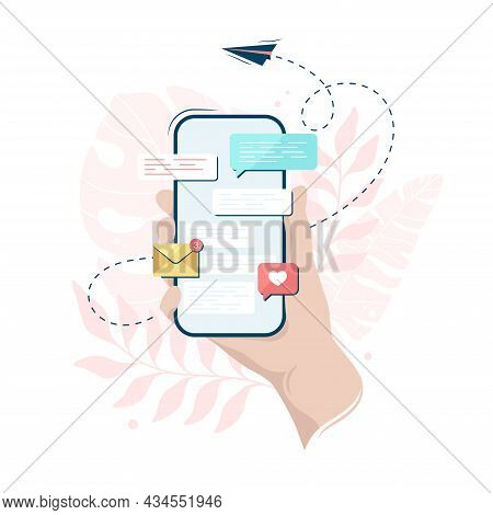 Hand Holding A Smartphone With A Messenger On Its Screen, On A Leaves Background