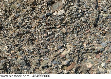 Natural Stone Texture. A Conglomerate Of Ancient Pebbles Cemented With Silicified Sand.