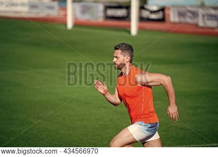 Best Exercise. Successful Fitness Sprinter. Male Coach On Stadium Running Track. Endurance And Stami