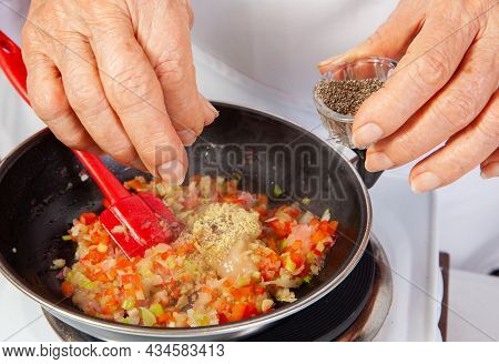 Preparation Of The Traditional Colombian Hogao Or Criollo Sauce (salsa Criolla) Made Of Onion, Tomat