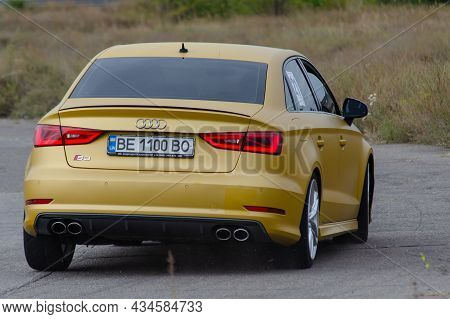 Rear View Yellow Sedan Drives At High Speed On A Paved Road. Audi Rs3 Sportback Quattro Car. Nikolae