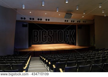 Palo Alto, California - September 29, 2021: Empty Stage Auditorium With Lit Stage And Black Curtain
