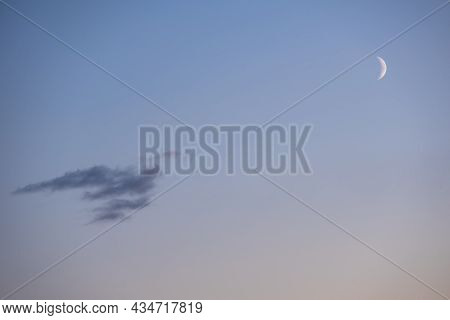 Half Moon In The Morning On Pink Sky With Clouds, Blue Hour. Dream Of A Magical Evening Sky With Moo