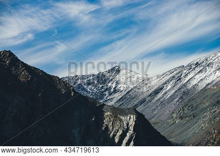 Picturesque Mountain Landscape With Snowy Pointy Top In Sunshine Under Cirrus Clouds In Blue Sky. Co