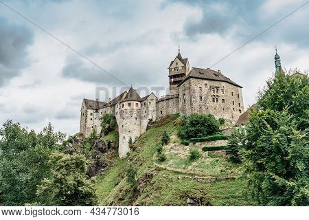Panoramic View Of Famous Medieval Town Of Loket,elbogen, With Colorful Houses And Stone Castle Above