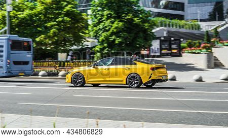 Moscow, Russia - July 2021: Kia K5 Optima Dl3 On The City Road. Fast Moving Yellow Shiny Korean Car 
