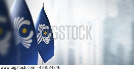 Small Flags Of Cis On A Blurry Background Of The City