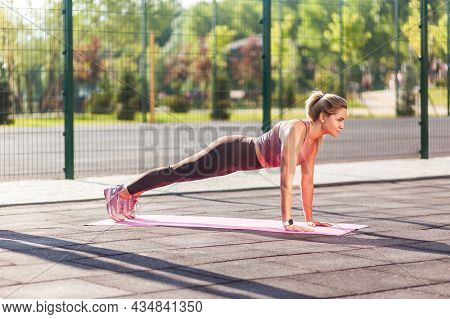 Full Length, Fit Beautiful Woman In Tight Pants Practicing Yoga On Mat Outdoor Summer Day, Doing Per